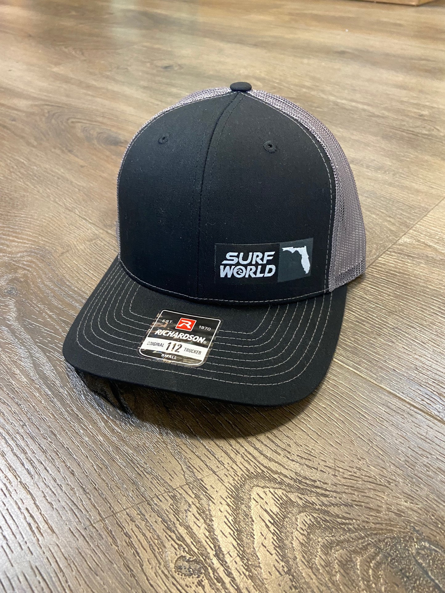 Surf World Florida Patch Trucker Hat Hats Blk Gry Side Logo