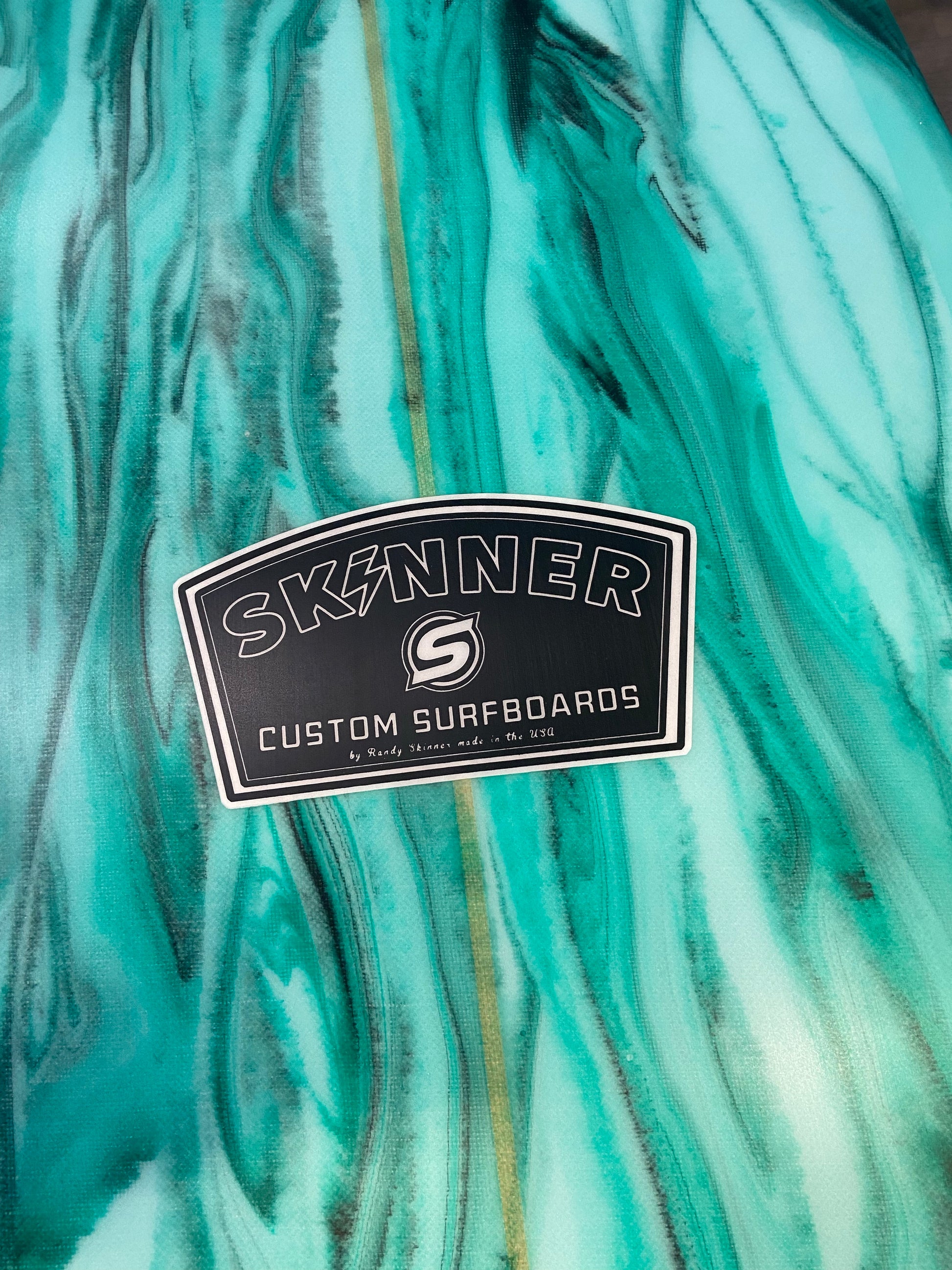 close up of resin art bottom skinner surfboards 